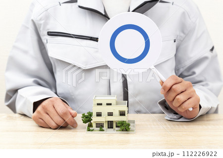 住宅模型の前でマル札を持つ手元 住宅模型の前でマル札を持つ手元 112226922