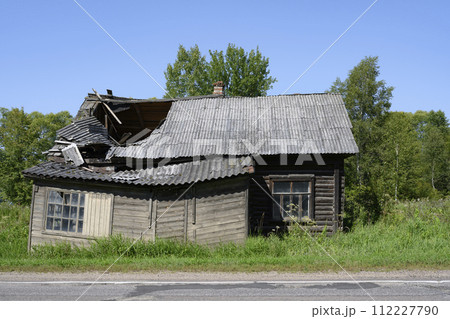 Abandoned dilapidated wooden village house by the road in Karelia Abandoned dilapidated wooden village house by the road in Karelia 112227790