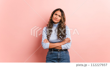 Upset woman with arms crossed standing disappointed Upset woman with arms crossed standing disappointed 112227937