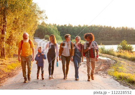 Multigenerational Friends on a Sunset Nature Walk Multigenerational Friends on a Sunset Nature Walk 112228552