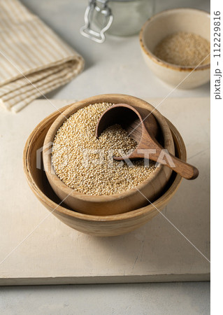 Dry quinoa uncooked in a wooden bowl. Healthy eating 112229816