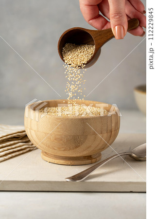 Dry quinoa uncooked in a bowl. Healthy eating Dry quinoa uncooked in a bowl. Healthy eating 112229845