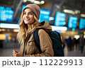 AI-generated content. Travel, happy young woman with backpack, at airport or train station.  112229913