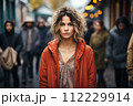 AI-generated content. Portrait of sad mature woman looking at camera. Evening, city view, outdoor.  112229914