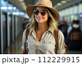 AI-generated content. Travel, happy young woman with backpack and sun hat, at airport or train station.  112229915