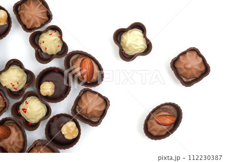 Collection of chocolates on a white background. Confectionery products, top view 112230387