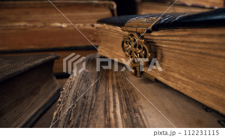 Macro view of saved medieval books with ancient writings. Religious literature Macro view of saved medieval books with ancient writings. Religious literature 112231115