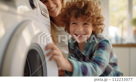 Caucasian mother and son washing clothes together in the house. 112233077
