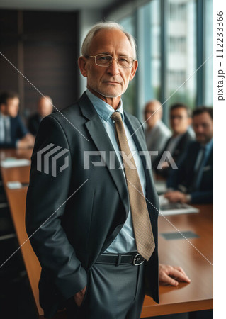 Senior Caucasian businessman standing in front of conference table with confidence in office. 112233366