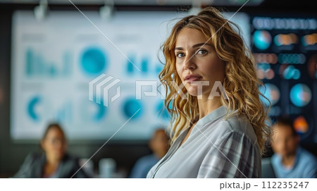 Woman With Blue Eyes Sitting in Front of Group of People 112235247