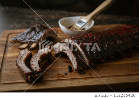 sliced barbeque spare ribs on wooden board sliced barbeque spare ribs on wooden board 112235426