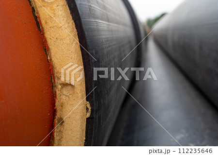 Steel pipe with heat insulation on construction site close up 112235646