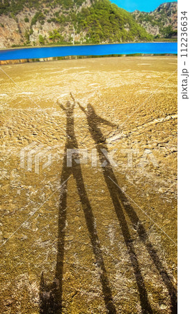 Couple shadow on beach, sunset lighting. Mediterranean Sea, Turkey. Couple shadow on beach, sunset lighting. Mediterranean Sea, Turkey. 112236634
