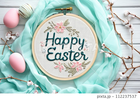 Embroidered Happy Easter message with floral embroidery and pastel eggs on turquoise fabric. Spring holiday concept for greeting card design Embroidered Happy Easter message with floral embroidery and pastel eggs on turquoise fabric. Spring holiday concept for greeting card design 112237537