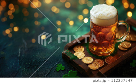 Foamy beer mug with clover and gold coins on wooden tray. Saint Patrick's Day celebration concept. Design for banner, greeting card, invitation 112237547