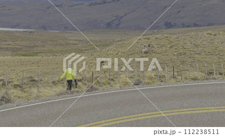 Photographer Capturing Condors on Mountain Road at Sunset 112238511