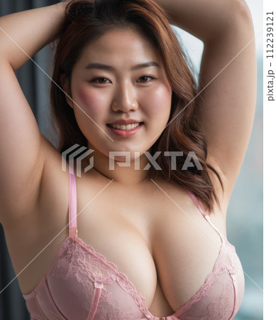 an asian woman in pink lingerie posing for the camera 112239121