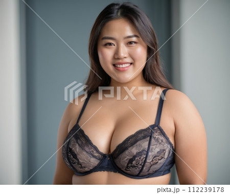an asian woman wearing a black lace bra 112239178