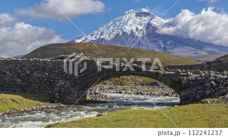 Cotopaxi volcano, old bridge and Pita river in the Cotopaxi national park Ecuador Cotopaxi volcano, old bridge and Pita river in the Cotopaxi national park Ecuador 112241237