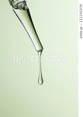 Clear liquid droplets falling from a dropper that can be used for cosmetic and medical images. 112242036