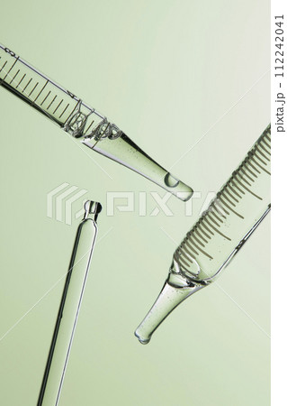 Clear liquid droplets falling from a dropper that can be used for cosmetic and medical images. 112242041