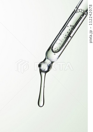 Clear liquid droplets falling from a dropper that can be used for cosmetic and medical images. 112242078