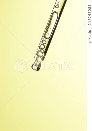 Clear liquid droplets falling from a dropper that can be used for cosmetic and medical images. Clear liquid droplets falling from a dropper that can be used for cosmetic and medical images. 112242085