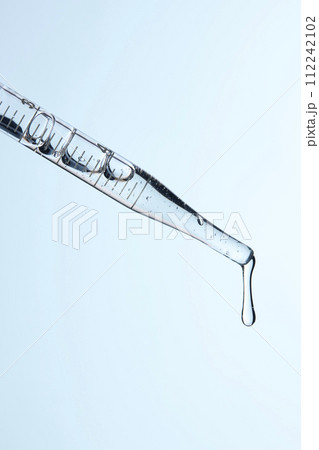 Clear liquid droplets falling from a dropper that can be used for cosmetic and medical images. 112242102