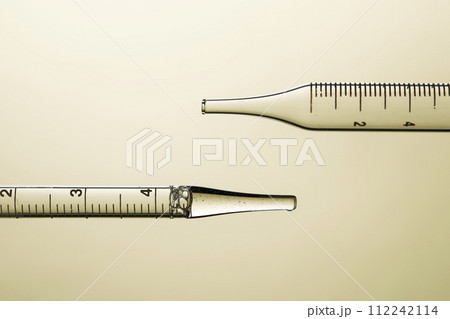 Clear liquid droplets falling from a dropper that can be used for cosmetic and medical images. 112242114