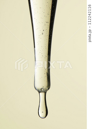 Clear liquid droplets falling from a dropper that can be used for cosmetic and medical images. 112242116