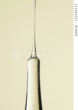 Clear liquid droplets falling from a dropper that can be used for cosmetic and medical images. 112242117