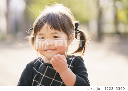 公園で微笑む小さな女の子 公園で微笑む小さな女の子 112243360