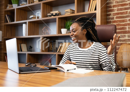 Woman Enjoying Video Call While Working From Home Woman Enjoying Video Call While Working From Home 112247472