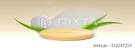 Wooden cylinder podium with green leaf or grass 112247723