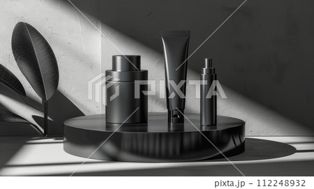 A collection of unbranded black beauty product packaging on a circular platform with a textured dark background illuminated by a slanted light beam, stand with copy space for text, mockup, template A collection of unbranded black beauty product packaging on a circular platform with a textured dark background illuminated by a slanted light beam, stand with copy space for text, mockup, template 112248932