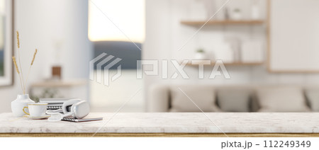 A presentation space on a luxury white marble table in a contemporary living room. 112249349
