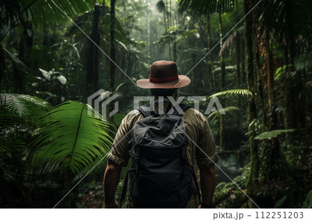 Adventurer exploring misty tropical rainforest Adventurer exploring misty tropical rainforest 112251203