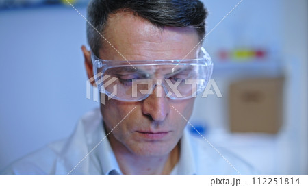 Focused male scientist checking the quality of food samples in laboratory Focused male scientist checking the quality of food samples in laboratory 112251814