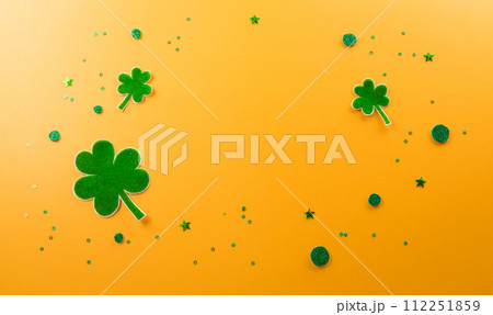 Happy St Patrick's Day decoration concept made from shamrocks ( clover leaf) on yellow background. 112251859