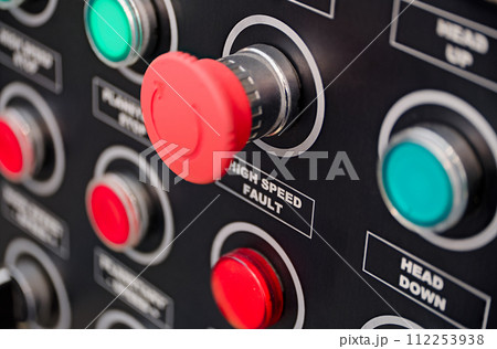Red and green round lamps and buttons on black control panel 112253938