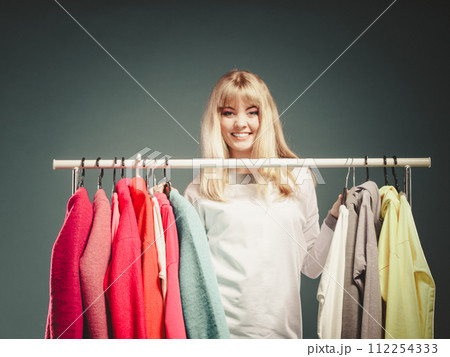 Woman choosing clothes to wear in mall or wardrobe 112254333