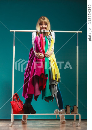 Funny woman taking all clothes in mall or wardrobe 112254340