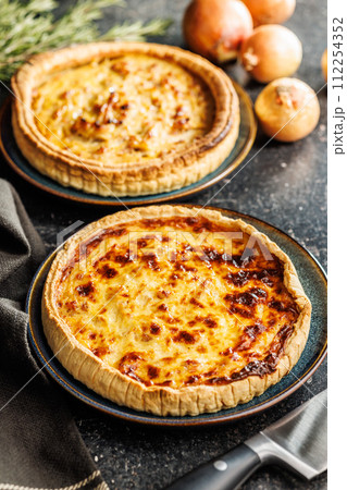 Traditional french pie. Quiche lorraine on kitchen table. 112254352
