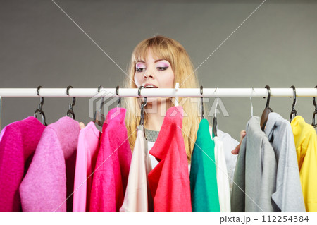 Pretty woman looking at clothes. Pretty woman looking at clothes. 112254384