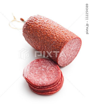 Sliced salami sausage isolated on white background. Sliced salami sausage isolated on white background. 112254389