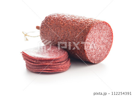 Sliced salami sausage isolated on white background. Sliced salami sausage isolated on white background. 112254391