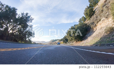 Basking in the beauty of a sunny winter day, driving on HWY 1 near Las Cruces, California offers stunning views of the picturesque coastal landscape against a backdrop of clear blue skies. Basking in the beauty of a sunny winter day, driving on HWY 1 near Las Cruces, California offers stunning views of the picturesque coastal landscape against a backdrop of clear blue skies. 112255643