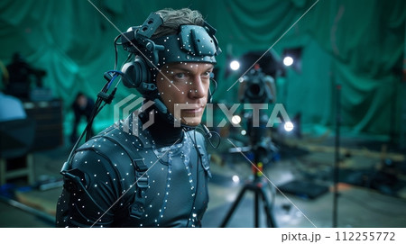 AI-generated content. Big film studio, professional crew shooting blockbuster movie. Using green screen with actor wearing motion tracking suit and head rig. 112255772