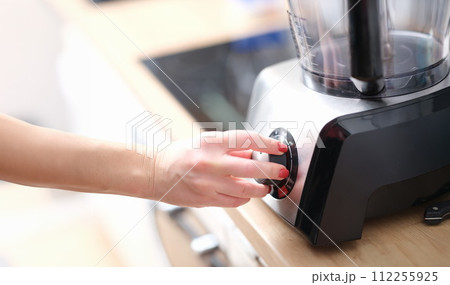 Woman hands switch gears on mixer in kitchen 112255925