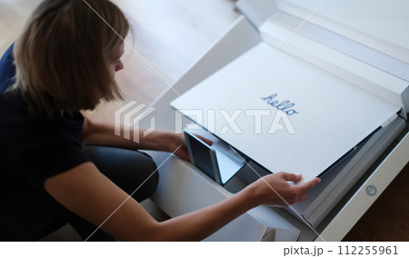 Tbilisi, Georgia - August 18, 2022: Woman takes out new iMac monitor from box 112255961